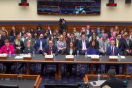 Six witnesses and a full audience sit at a House Judiciary Committee hearing.